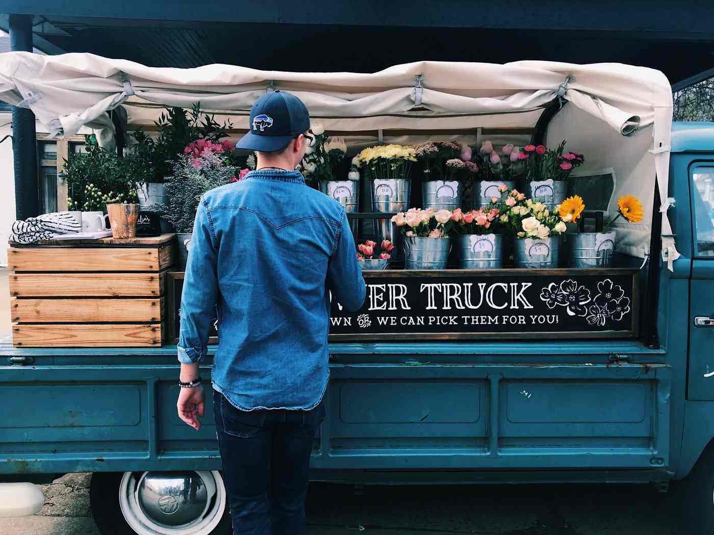 man in front of blue flower truck - how to succeed when you become a florist